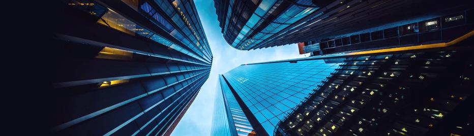 Looking up at three tall buildings